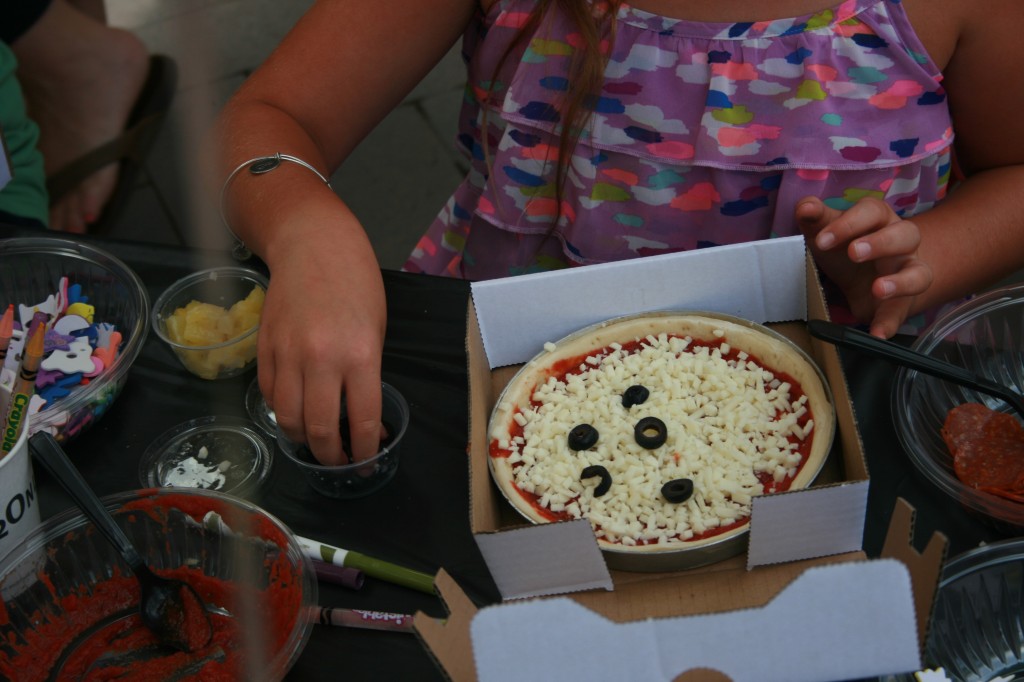 decorating her pizza